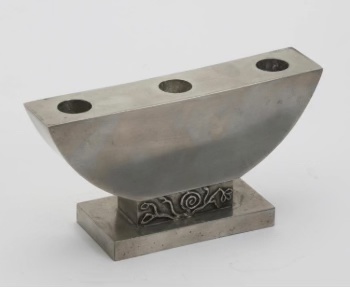 Metalwork candlestick for three candles by Sylvia Stave.